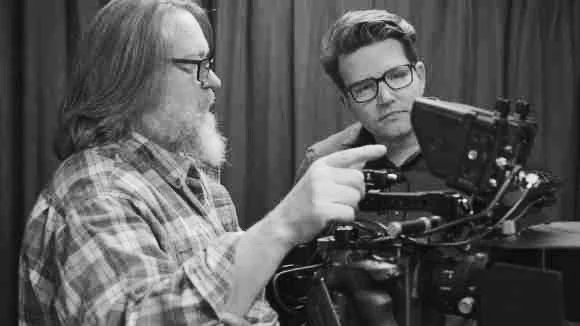 Two filmmakers review a cinema camera together.