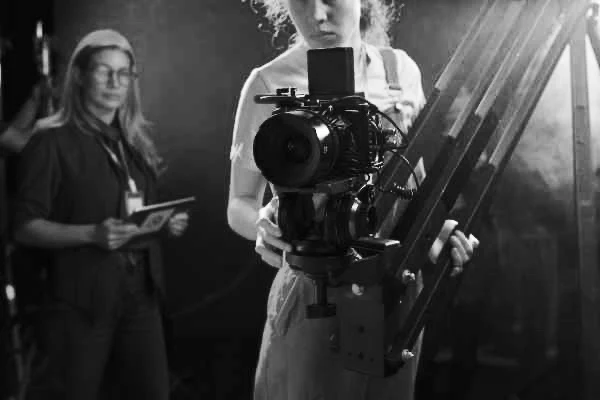 A film crew works with a camera mounted on a jib.
