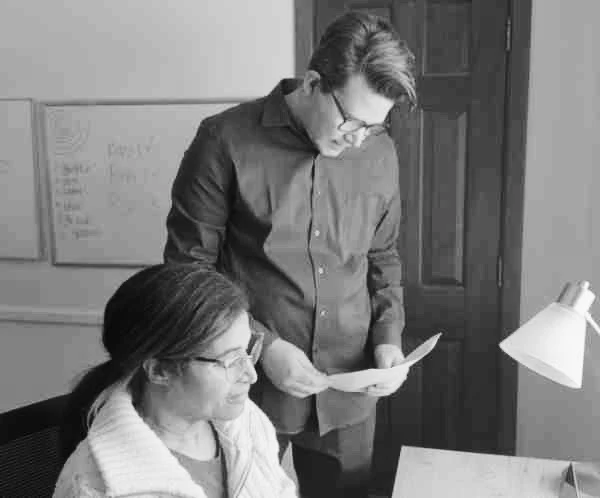 Two filmmakers work together on a script.